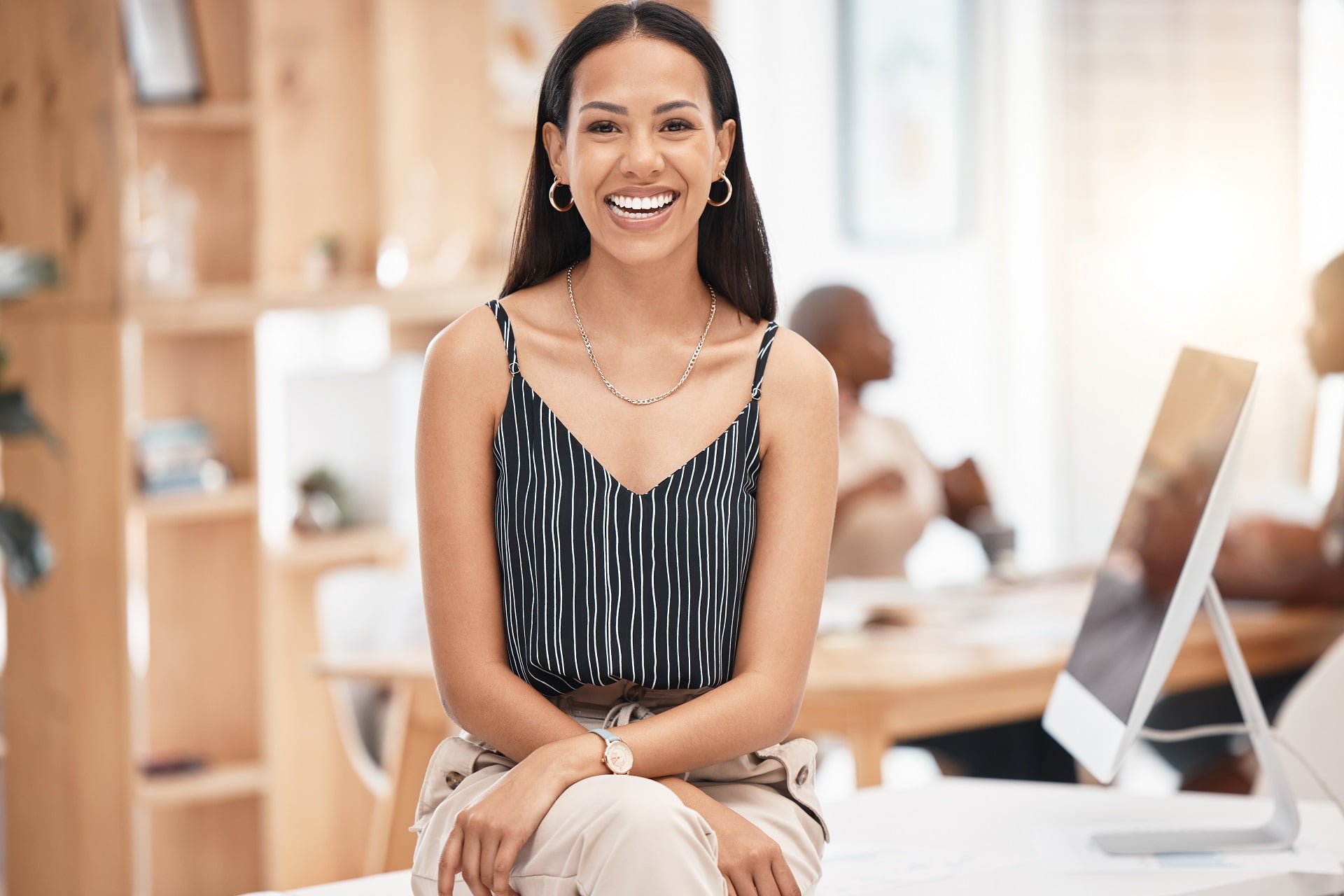 Smile, happy and business woman, desk portrait at work with blurred background. Leadership, motivat.